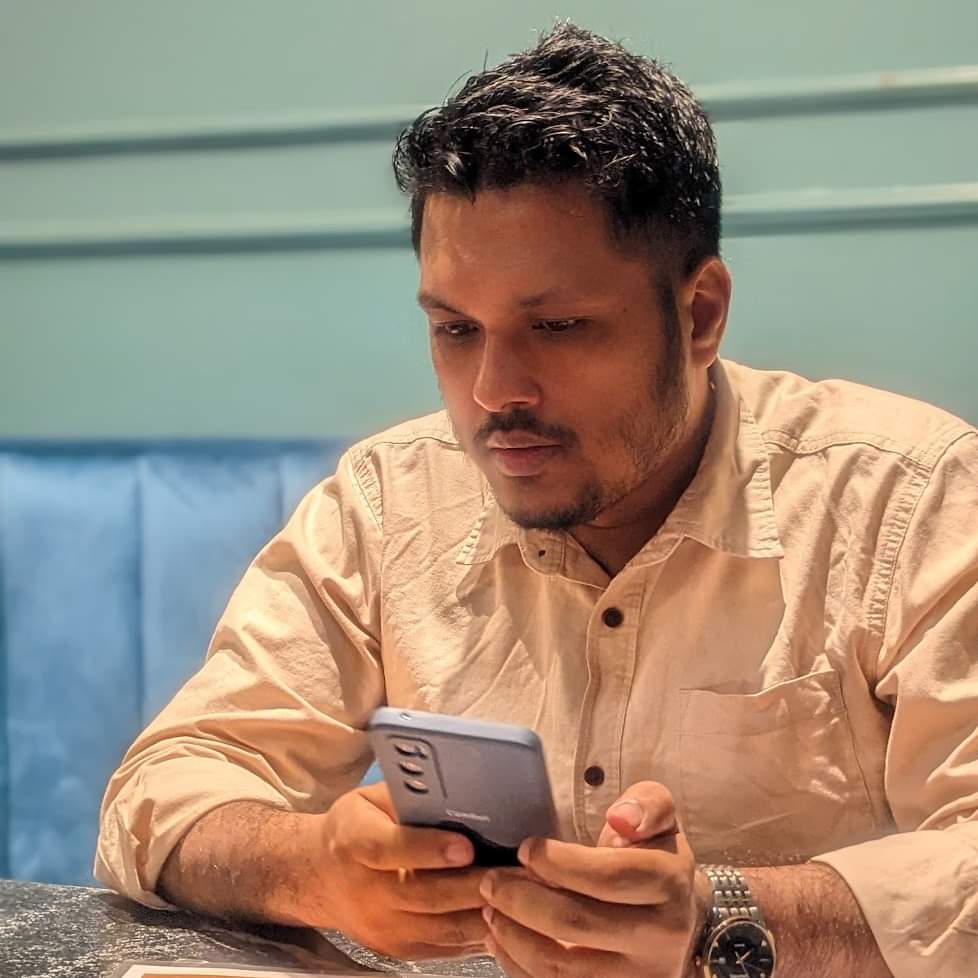 Javed Rasin scrolling on his phone